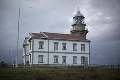 Cabo Peñas Lighthouse in Asturias under a cloudy sky