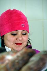 Young lady selling fish at Mercado Central in Santiago, Chile