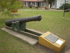 18th-century muzzle-loading cannon on display in a garden