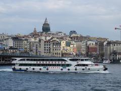 The ferry Kaptan Ilyas Mert in front of the Galata Bridge and tower