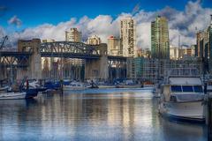 Sunny day on False Creek with boats and buildings in the background