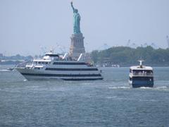 Statue of Liberty in New York Harbor with cityscape in the background