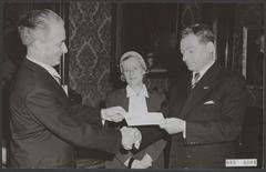 Person named Alons assisting others with checks and offers, Amsterdam, 1954