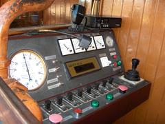 Interior of a driver's cab in a modern train with various controls and screens