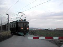 Tram crossing a level crossing in Sóller, Mallorca with mountains in the background