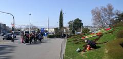 Flower clock at Jardin Anglais in Geneva with tourists and gardener