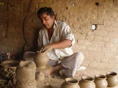 Clay artist working on a thrower in Gujarat, Pakistan