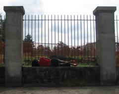 Woman resting on a wall in Armstrong Park, New Orleans