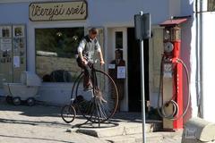 A group of people riding vintage bicycles in Loket, Czech Republic