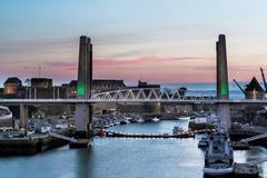 sunset over Penfeld River with castle, bridge, and Tanguy tower in Brest