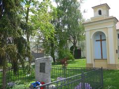 village square with a war memorial in Jenštejn