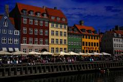 Colorful buildings along Nyhavn canal in Copenhagen with moored boats