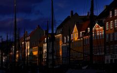 Nyhavn in Copenhagen with colorful buildings lining the canal and boats docked along the sides