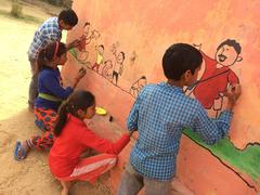 children painting walls at Uday Community School