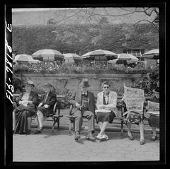 People sitting on benches in front of the Central Park Zoo restaurant