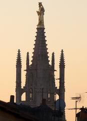 Golden statue on Pey-Berland tower with Saint-André Cathedral towers in Bordeaux