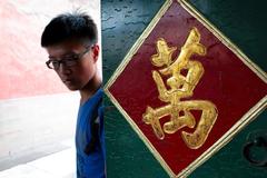 People walking in front of a temple in Beijing, China