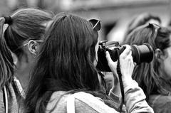 Women photographing a demonstration at Restauradores in Lisbon