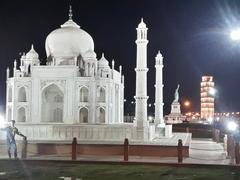 Taj Mahal with a reflection in the surrounding pool under a clear blue sky