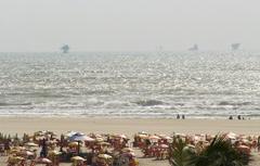 Praia de Atalaia in Aracaju with palm trees, sand, and people enjoying the beach