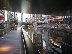 Dotonbori at night with brightly lit buildings and billboards reflected on the canal