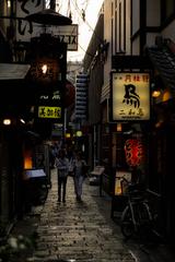 Alleyway In Old Town Osaka at night with street lights illuminating the scene