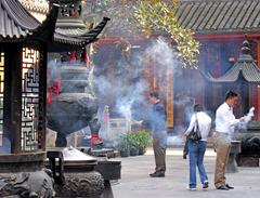 People burning incense to Buddha at Jade Buddha Temple