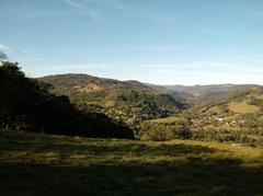 Aerial view of Padilha District in Taquara, Rio Grande do Sul, Brazil, surrounded by native trees and houses near Rio Padilha