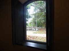 large wooden window overlooking a square and river