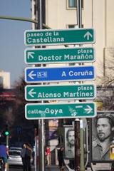 road sign in Madrid showing directions to Paseo de la Castellana, Plaza Doctor Maranon, A-6 A Coruna, Plaza Alonso Martinez, and Calle Goya