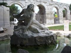 Sculpture fountain in front of Roman theater in Arles, Provence