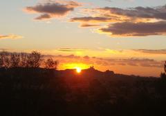 Sunset framed in the gap of the old quarry behind Notre-Dame de la Garde, viewed from the eastern districts of Marseille