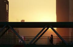 Person walking across a bridge in Hong Kong