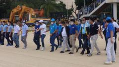 Government officials inspecting Manila Bay beach during partial opening