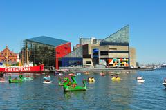 Baltimore National Aquarium building with large glass panel facade and reflecting pool