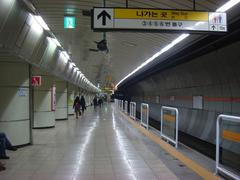 Daechi Station entrance with modern architectural design and people walking nearby