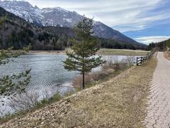 Scenic path around Lake Andalo with mountains in the background