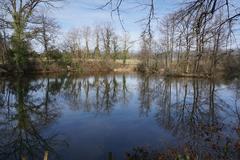 Small lake called Das Bassin near Solitude Palace in Stuttgart, surrounded by lush greenery and trees