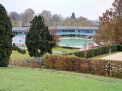 Renovated traditional mineral bath Bad Berg in Stuttgart with outdoor swimming pool surrounded by greenery