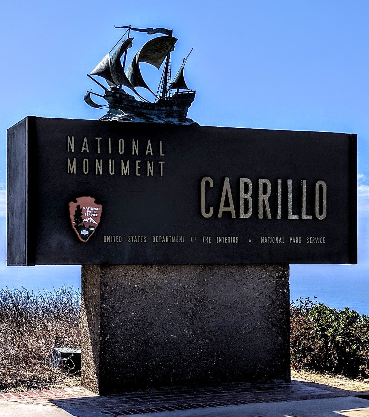 Entrance of Cabrillo National Monument with American flag and historic surroundings