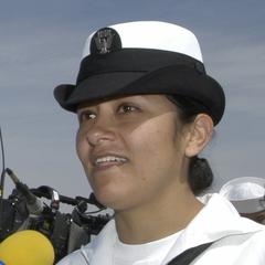 Storekeeper 2nd Class Leonor Arellano being interviewed by television news reporters at Cabrillo National Monument San Diego during a naturalization ceremony on May 1, 2003