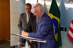 U.S. Chargé d'Affaires Douglas Koneff with Sebrae representative Bruno Quick signing MOU to implement SBDC technology in Brazil