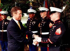 Secretary of Defense William S. Cohen presenting mementos to U.S. Marines at the U.S. Embassy in Brasilia, Brazil on May 27, 1998
