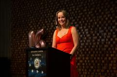Dr. Cristina Castro receiving Women who Make a Difference award for activism to end violence against women during speech