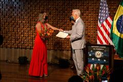 Dr. Cristina Castro receiving the Women Who Make a Difference award from U.S. Chargé d'Affairs Douglas Koneff at Casa Thomas Jefferson