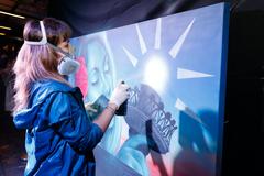 Artist Clara Leff creating live artwork celebrating immigrant contributions to US culture