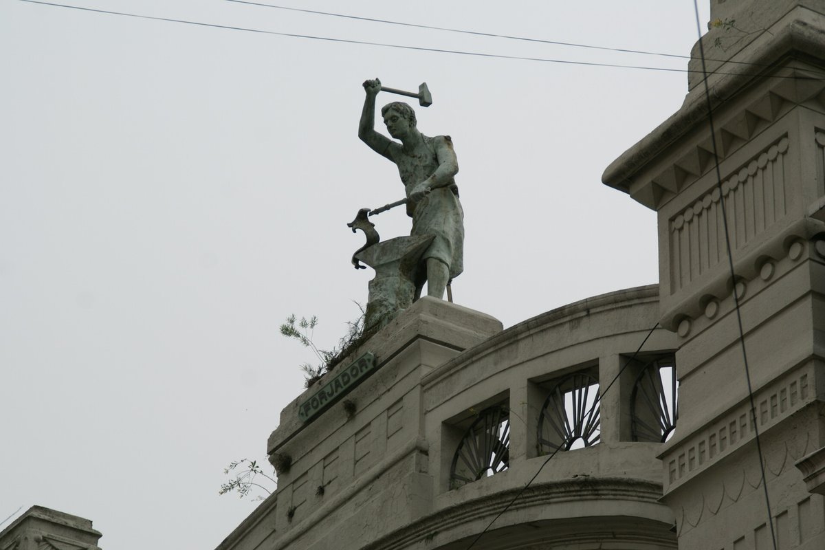 Statue of a blacksmith on the facade of a building at Calle Perú in San Telmo, Buenos Aires