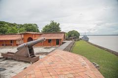 View of Forte do Presépio in Belém, Pará with historic stone fortification and flags under cloudy sky