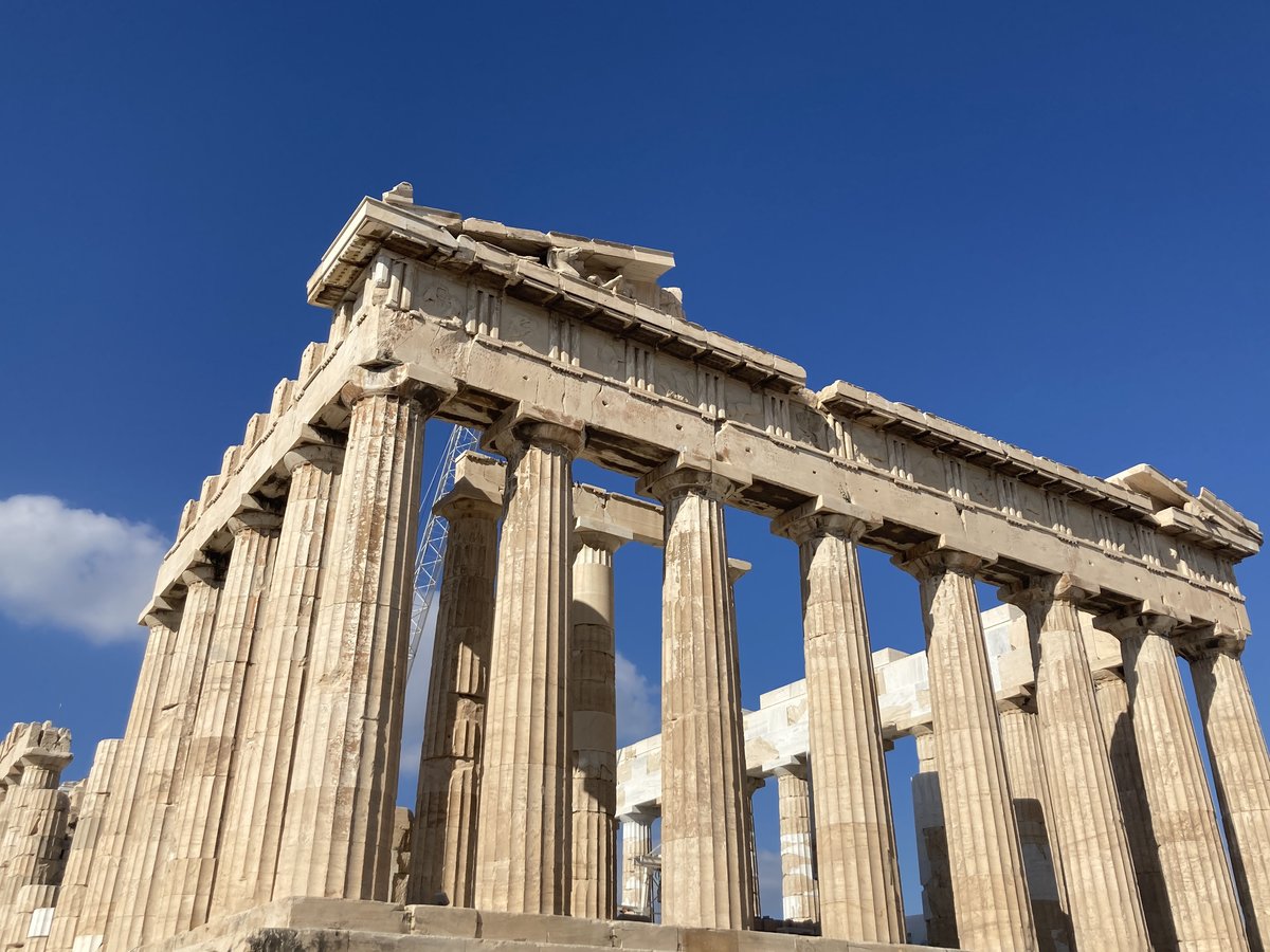 View of the Acropolis in Athens at sunset with ancient ruins and clear sky