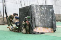 Marines and civilians engaged in paintball battle on Marine Corps Air Station Miramar paintball course